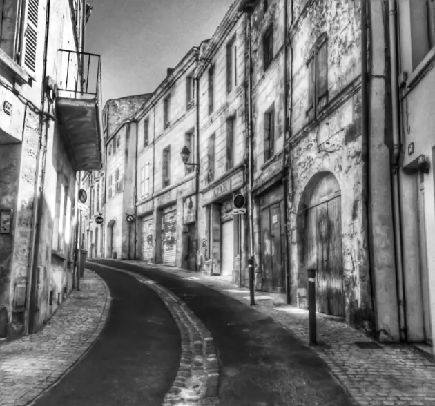 black and white painting of a narrow historic european street with old buildings